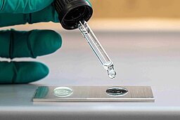 Plasmatreat lab technician testing liquid.